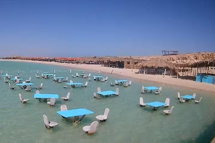 Orange Bay beach lagoon with water tables and chairs, ideal stop on Hurghada snorkeling day trip with lunch