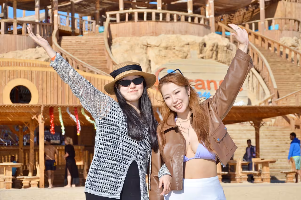 Friends posing at Orange Bay Island beach club on Hurghada snorkeling trip with lunch and island time