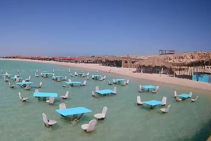 Floating lagoon tables and chairs at Orange Bay Island beach, Red Sea stop on VIP snorkeling trip Hurghada