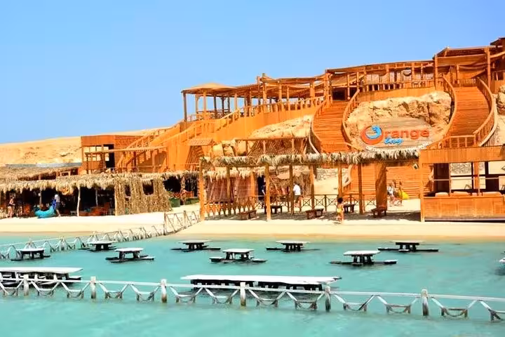 Orange Bay Island beach club in Hurghada with wooden decks and turquoise lagoon on VIP snorkeling day trip