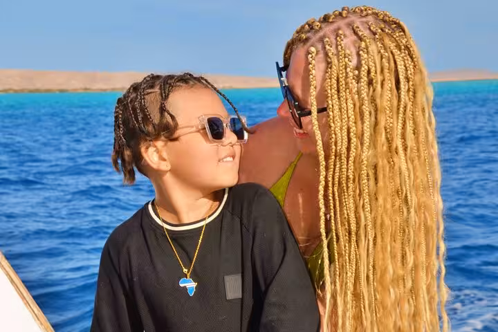 Mother and child on boat to Orange Bay Hurghada, Red Sea snorkeling excursion with lunch, drinks and water sports