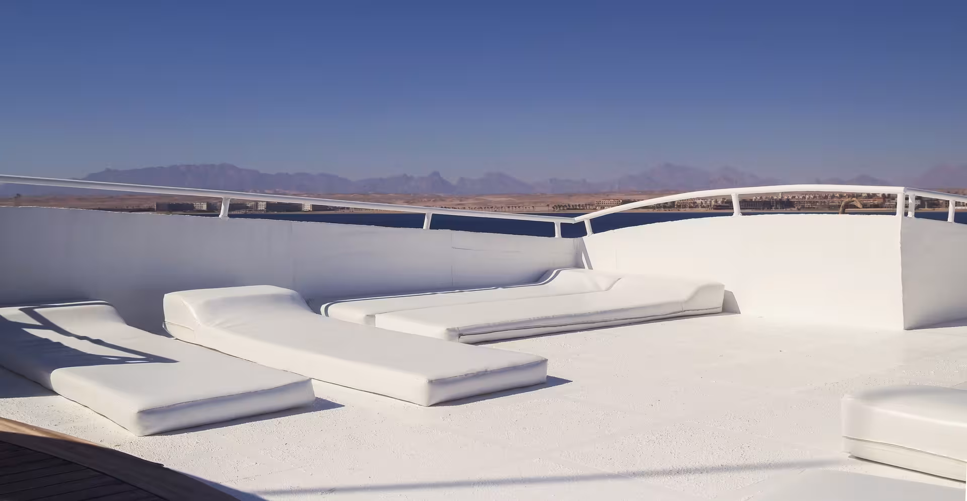 Sun deck lounge on Hurghada boat for Orange Bay Island snorkeling tour, relaxing seats and Red Sea panorama