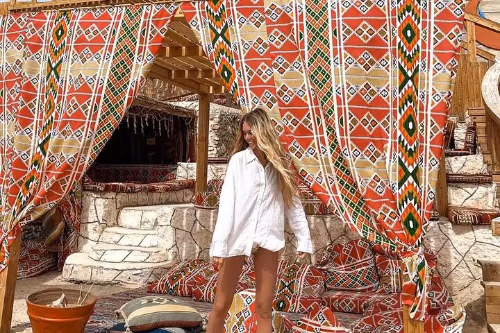 Relaxing at Orange Island Hurghada beach camp with colorful Bedouin-style tent lounge and cushions