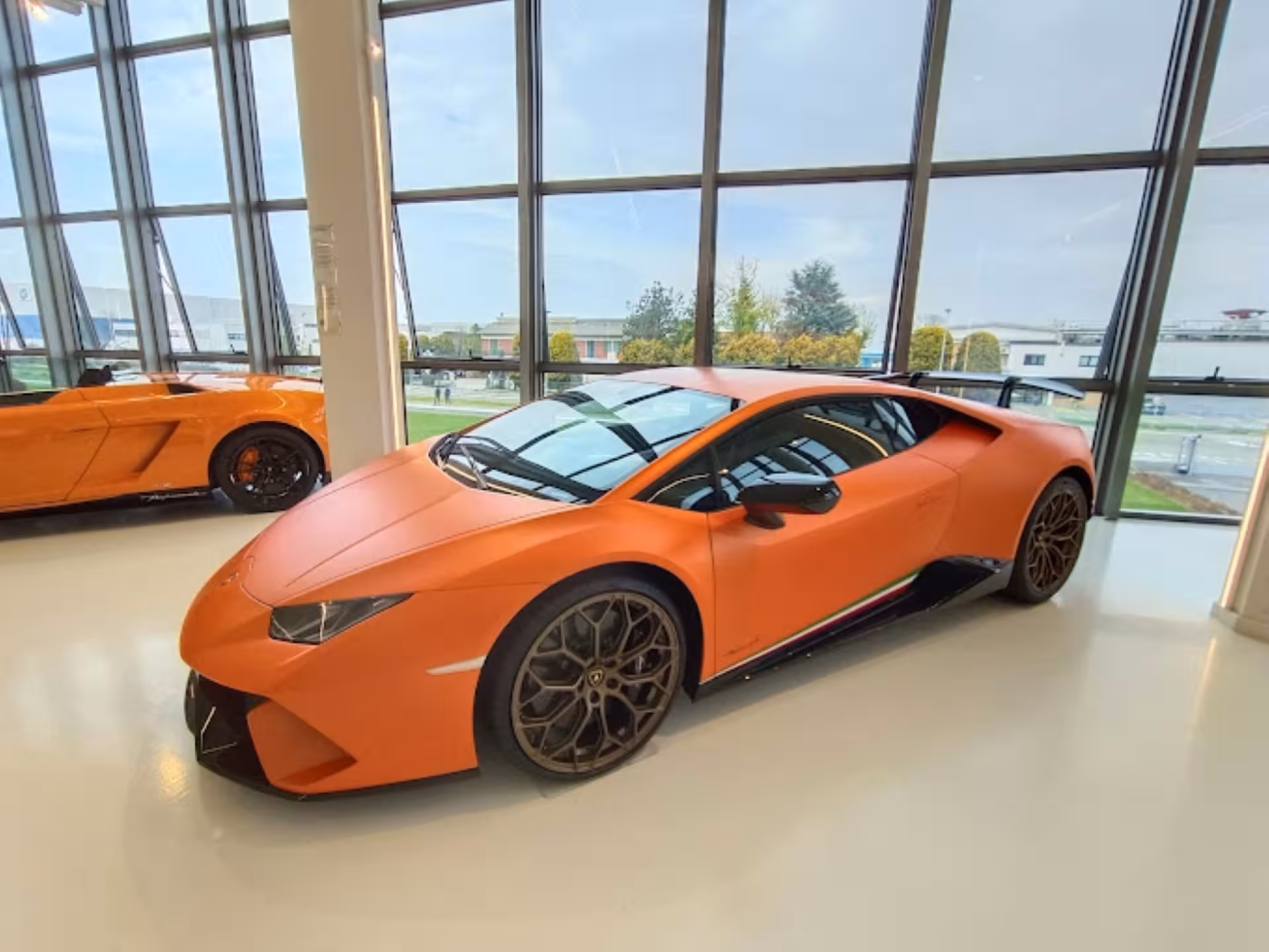 Orange Lamborghini Huracán in the Lamborghini Museum gallery, included in combo visit with Ducati and Ferrari museums