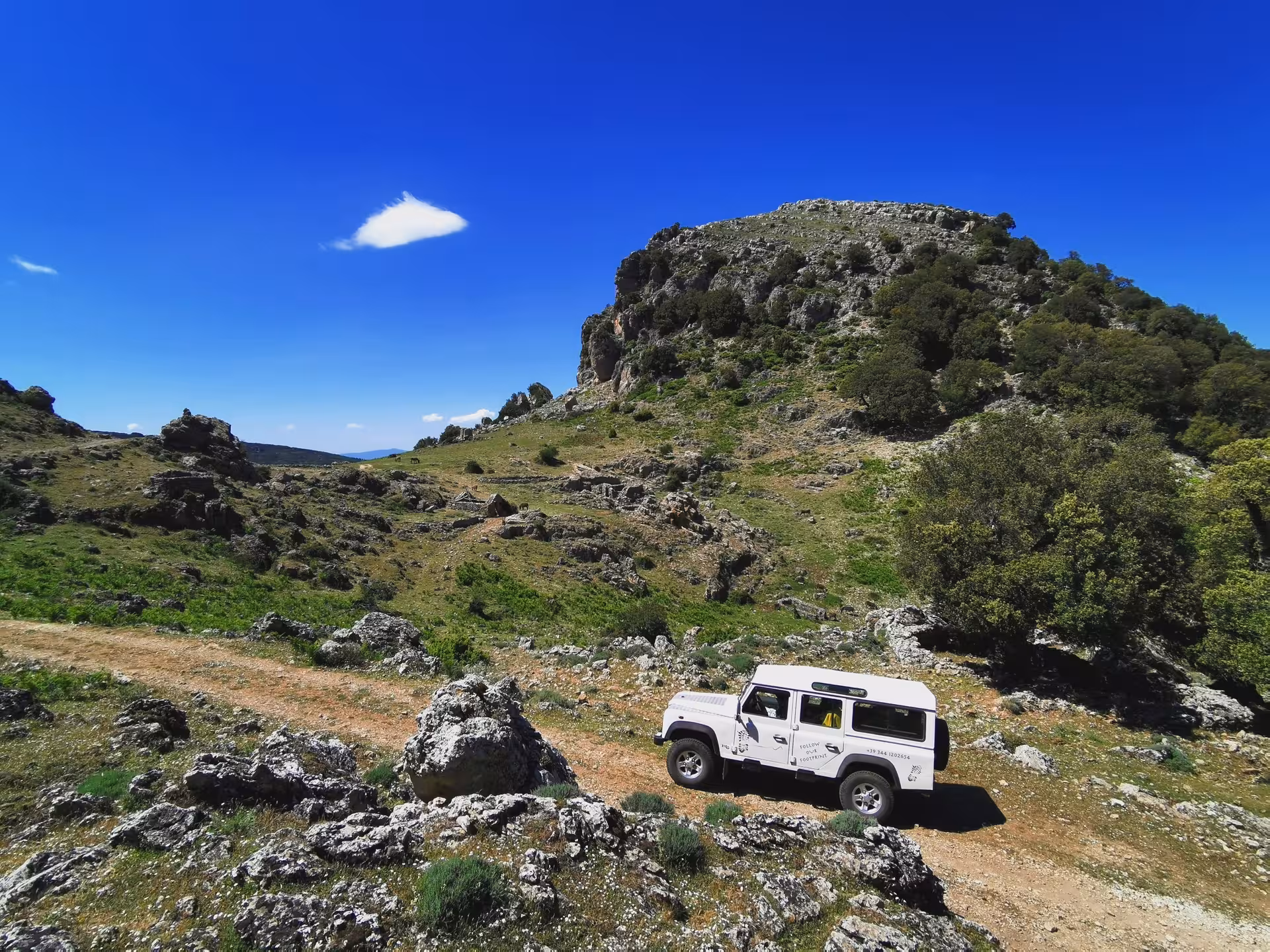 4x4 Jeep traversing rugged Sardinian landscape near Orgosolo, perfect for adventure seekers on the Orosei tour.