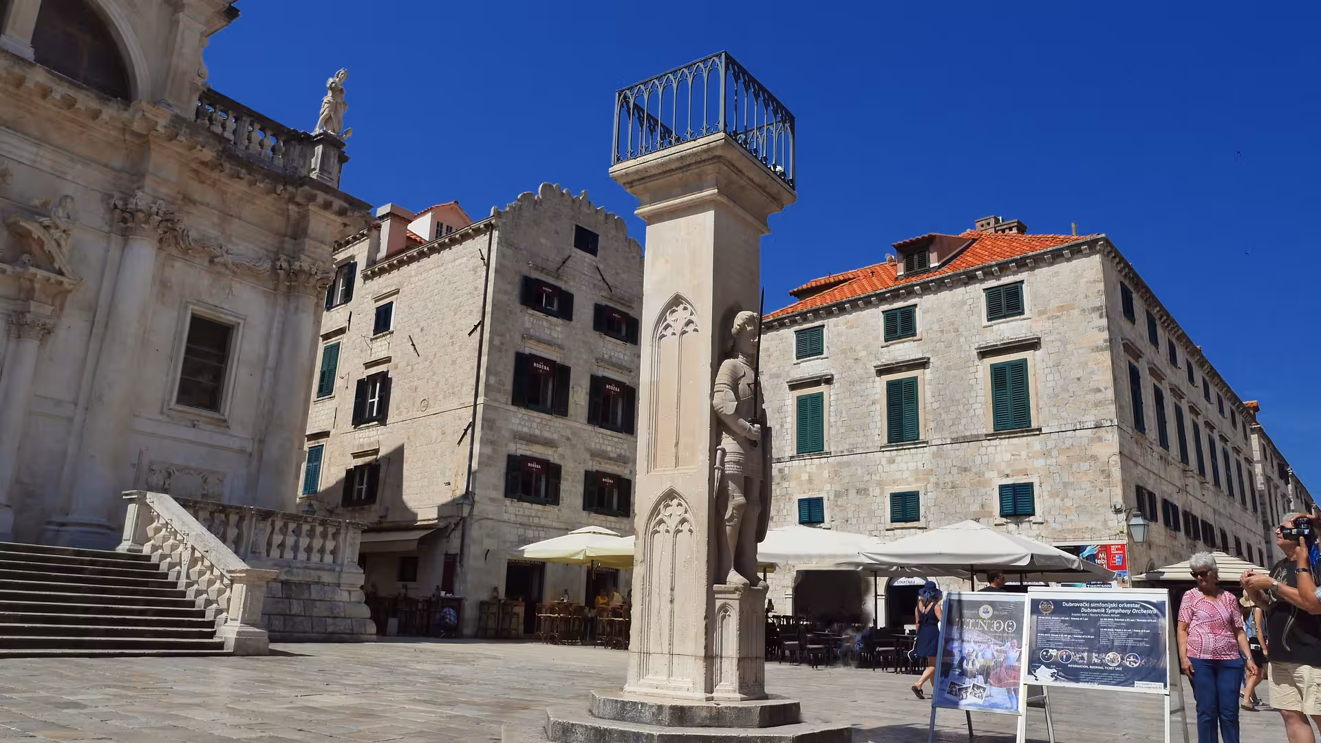 Orlando’s Column in Dubrovnik Old Town square beside historic stone buildings on a guided city tour