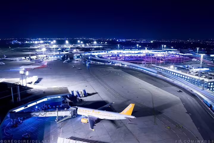Night view of Orly Airport runway and terminal, ideal for private transfer from Orly Airport to Paris