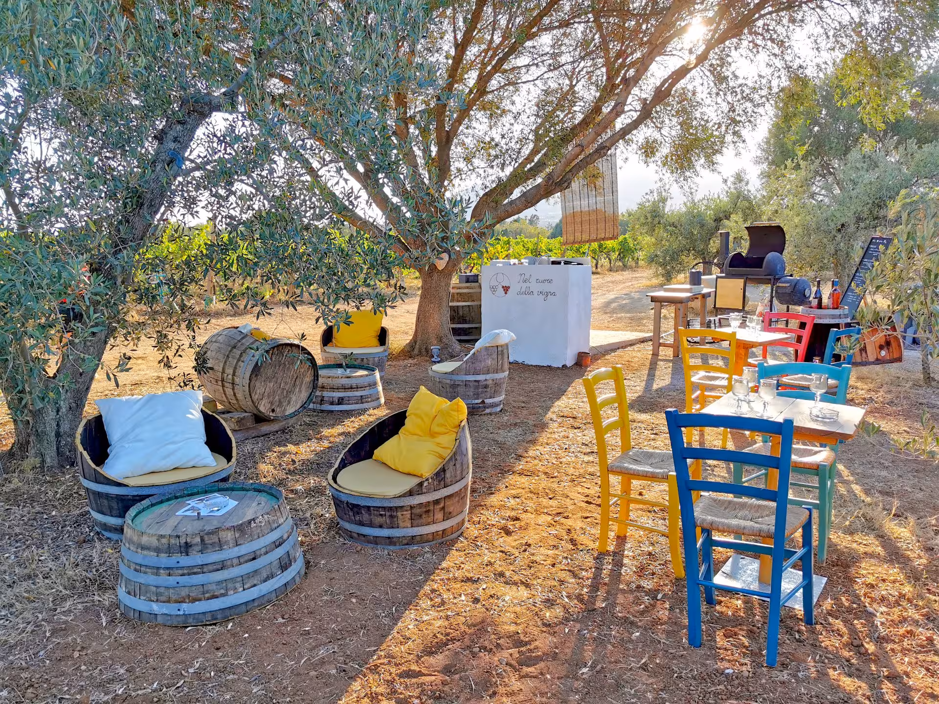 Rustic outdoor seating in Sardinia's countryside, perfect for enjoying local cuisine on an Orosei jeep tour.