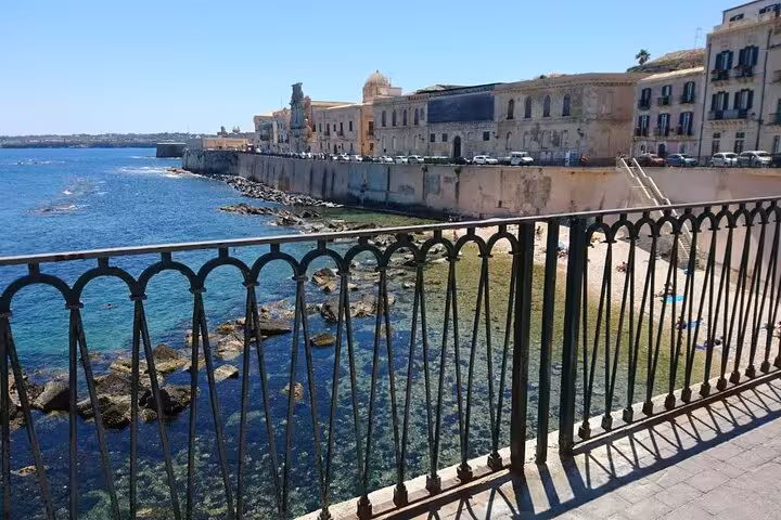 Stroll along Ortigia's scenic waterfront promenade, offering breathtaking views of the Syracuse coastline.