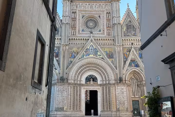Ornate Gothic facade of Orvieto Cathedral visited on a private transfer tour from Rome with professional driver