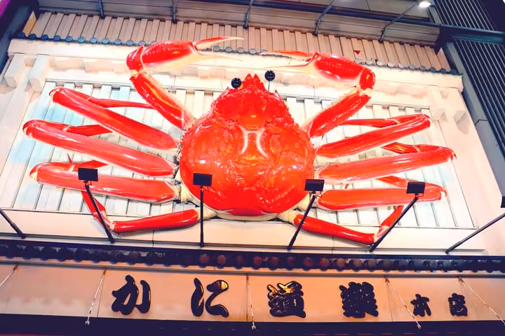 Giant illuminated red crab sculpture above Kani Doraku restaurant entrance in Osaka, Japan