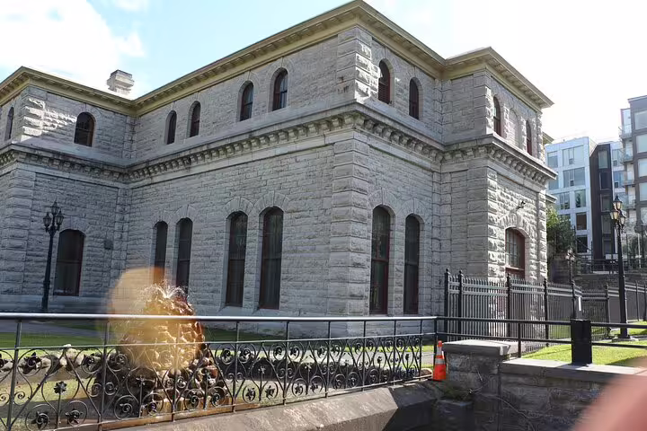 Historic stone building with arched windows and iron fence on Ottawa self-guided walking tour route