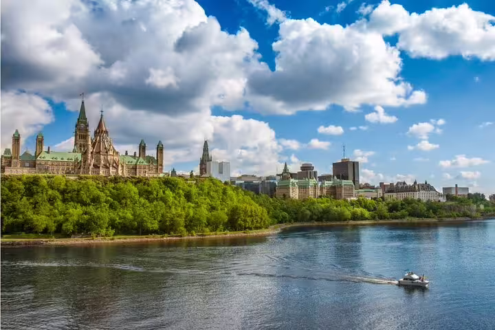 Ottawa Parliament Hill and the Ottawa River with a boat on a sunny summer day