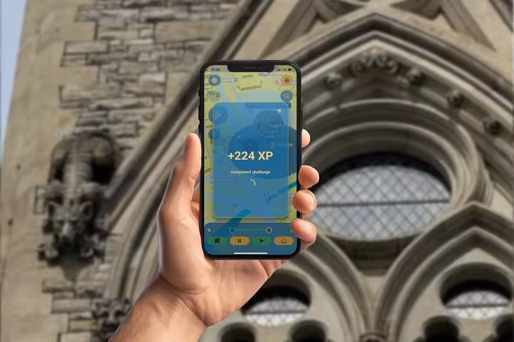 Hand holding smartphone showing +224 XP completed challenge on wildlife scavenger hunt app outside Ottawa stone church