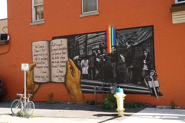 Street art mural in Ottawa depicting Canada's first civil rights demonstration with rainbow and open book