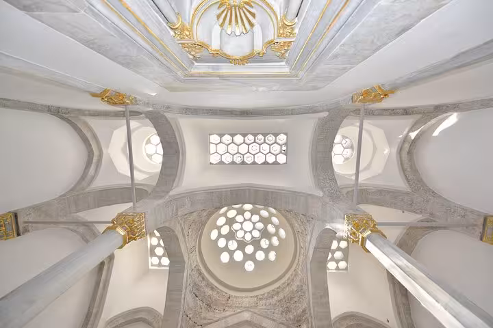Ottoman mosque interior ceiling with domes and arches, seen on Istanbul history and culture half-day guided tour