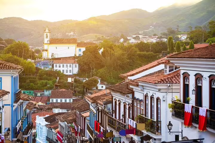 Scenic view of Ouro Preto's colonial buildings and church at sunset on the Gold Route tour.