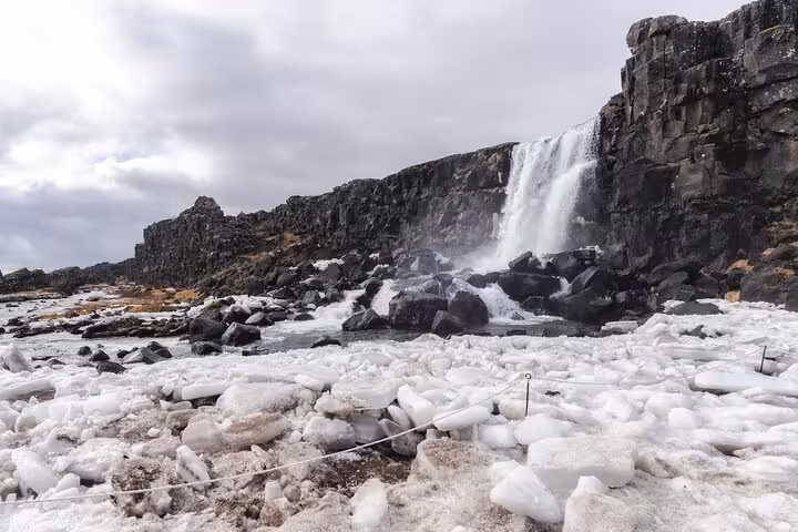 Öxará river frozen with ice chunks below Öxarárfoss waterfall at Þingvellir, Iceland in winter