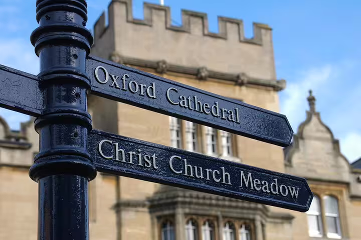 Signpost to Oxford Cathedral and Christ Church Meadow, highlighting iconic sights on a private day trip from London with lunch.