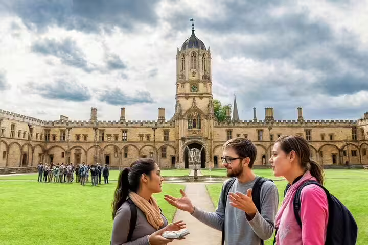 Tourists enjoy a guided tour at Christ Church College, Oxford, with its stunning architecture and vibrant history, during a day trip from London.