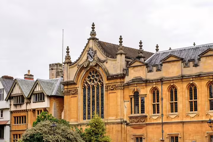 Historic Oxford college hall with Gothic window and stonework, key clue stop on self-guided scavenger hunt