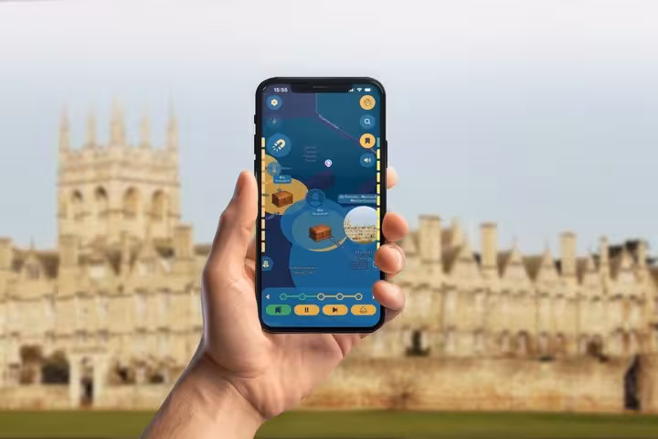 Hand holding smartphone with GPS walking tour app showing Oxford city map with landmarks