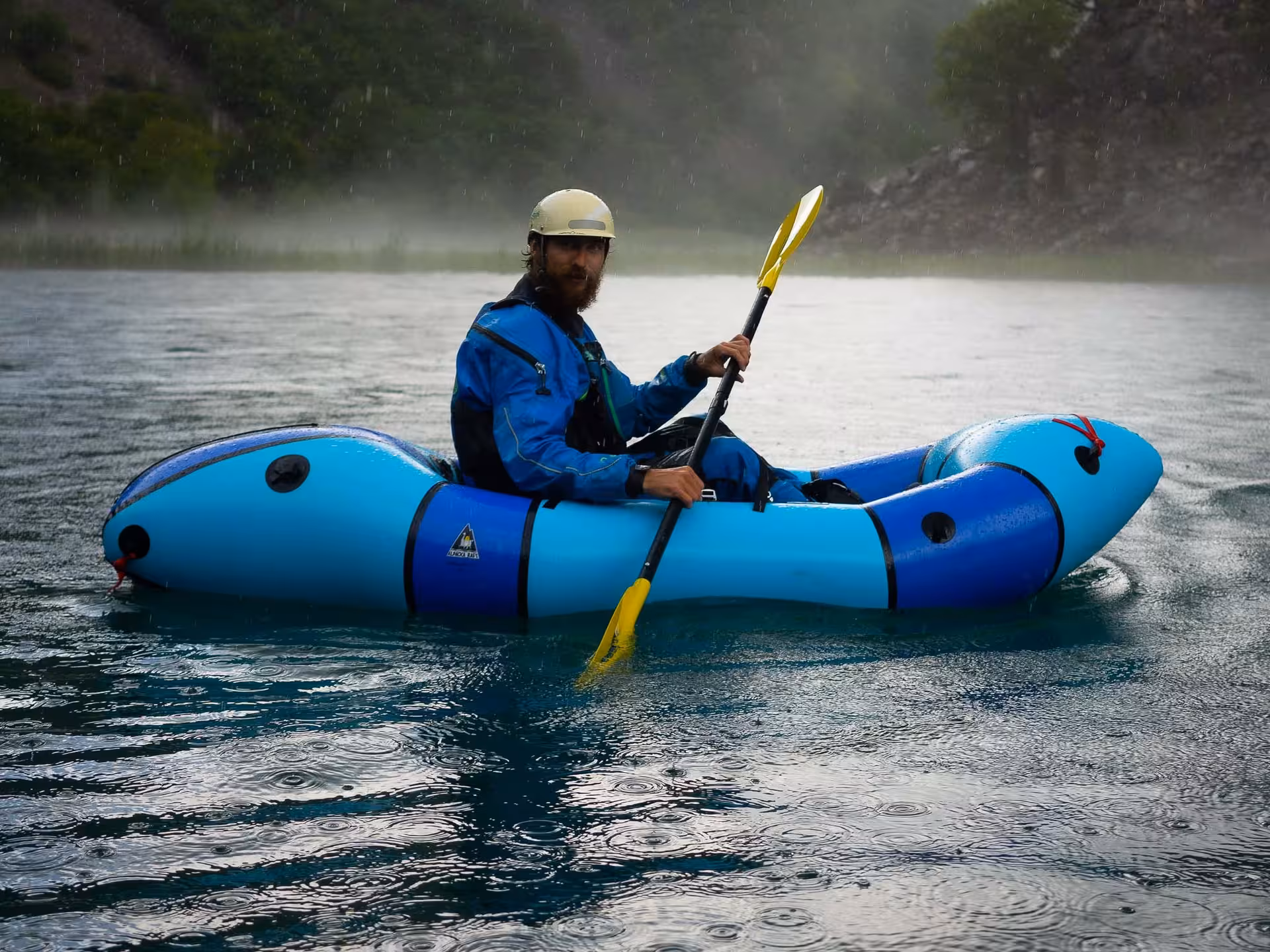 Adventurer packrafting on Zrmanja River surrounded by misty scenery, perfect for Croatia outdoor activities.