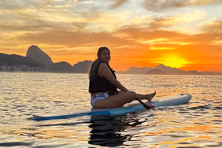 Paddleboard at Copacabana's sunrise, embracing tranquil waters and picturesque landscapes on this unique SUP adventure.