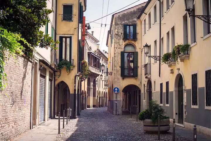 Charming cobblestone street in historic Padua, Italy, explored on a self-guided scavenger hunt walking tour
