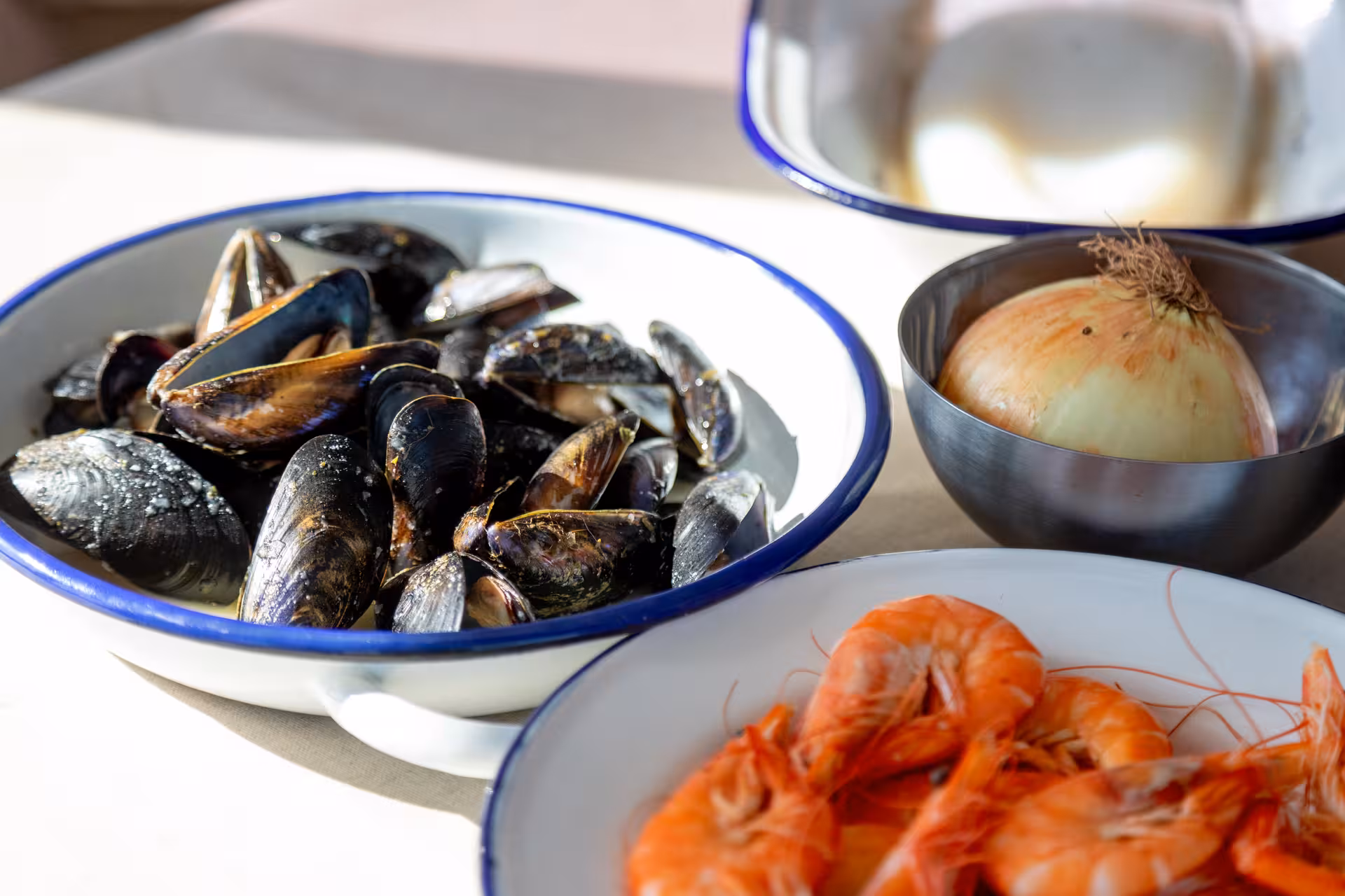 Fresh mussels, prawns and onion prepped for Paella Masterclass, showcasing authentic Spanish seafood paella ingredients