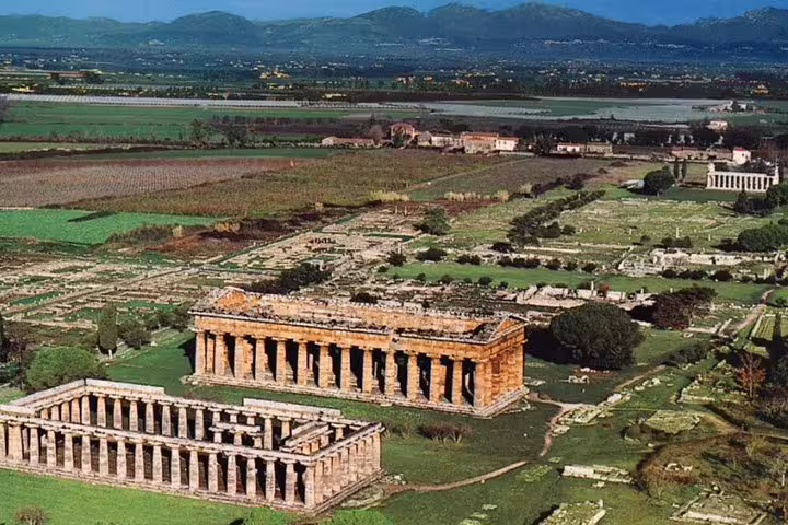 Panoramic aerial shot of Paestum Greek temples and countryside, showcasing the UNESCO-listed ruins on a private tour