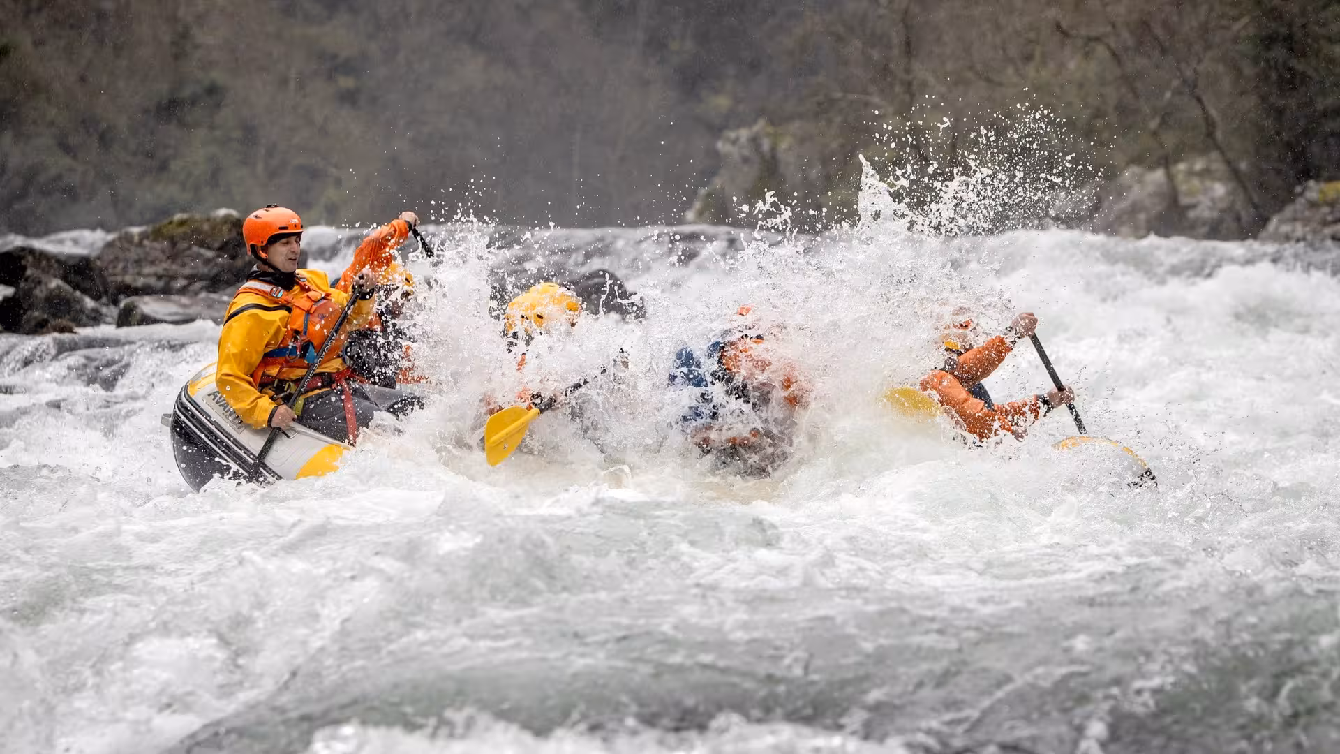 Rafting through Paiva River rapids near Porto, Portugal, with guide and team hitting wild whitewater