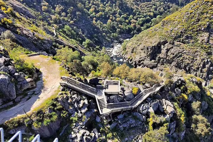 Scenic view of Paiva Walkways and lush Arouca Valley, showcasing rugged landscapes and winding wooden pathways for adventure tours.