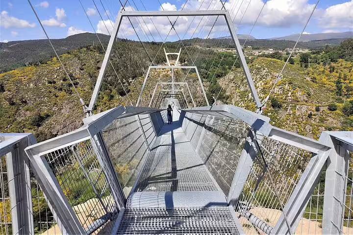 Suspension bridge with stunning views of lush landscapes on the Paiva Walkways tour from Porto to Aveiro, Portugal.