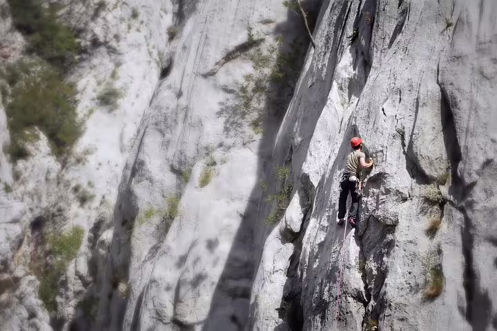 Rock climber scaling a steep limestone wall in Paklenica National Park, Croatia, a top Velebit climbing spot