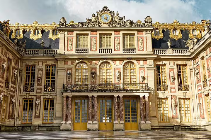 Elegant view of the ornate exterior of the Palace of Versailles seen during a guided tour from Paris.