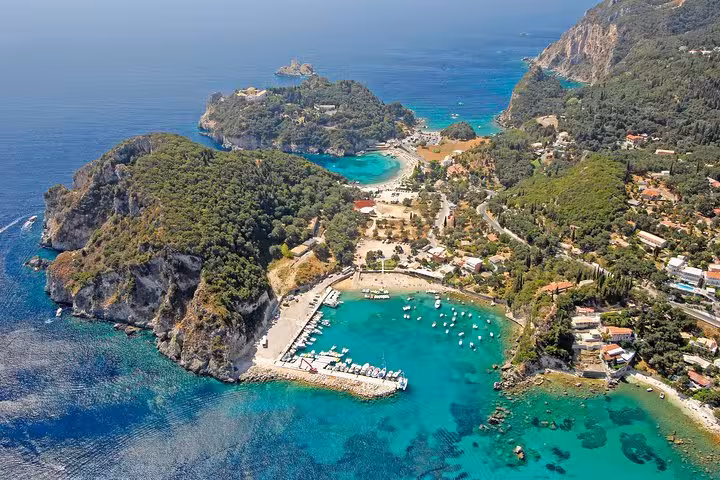 Aerial view of Palaiokastritsa bays in Corfu with turquoise water and boats, scenic stop on private tour and tastings