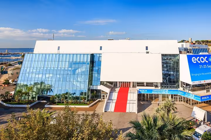 Palais des Festivals in Cannes with red carpet entrance and ECOC conference banners, French Riviera