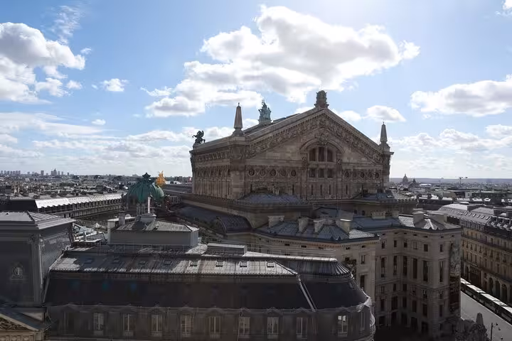 Rooftop view of Palais Garnier, a Second Empire landmark on Napoleon III Paris city tour under blue sky