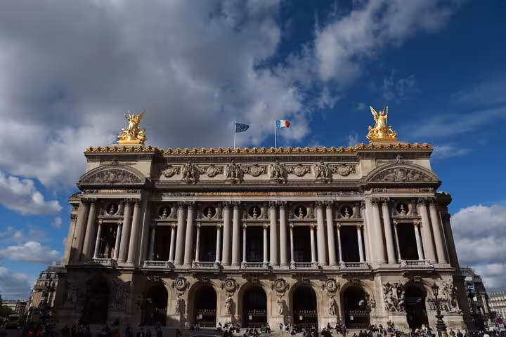 Front view of Palais Garnier with gilded statues, iconic Second Empire stop on Napoleon III Paris city tour