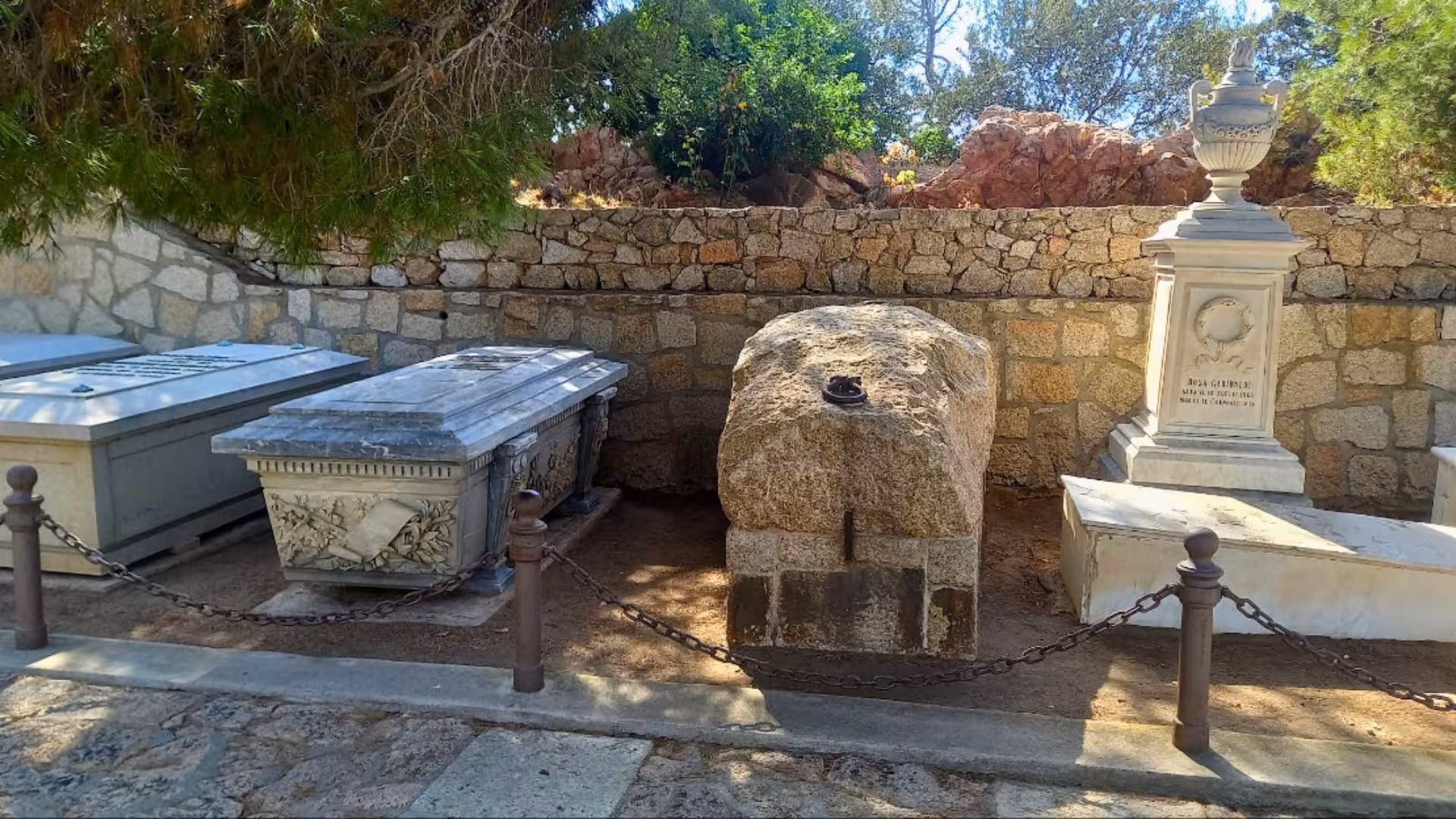 Stone and marble tombs in a historic cemetery in La Maddalena, highlighting archaeological significance.
