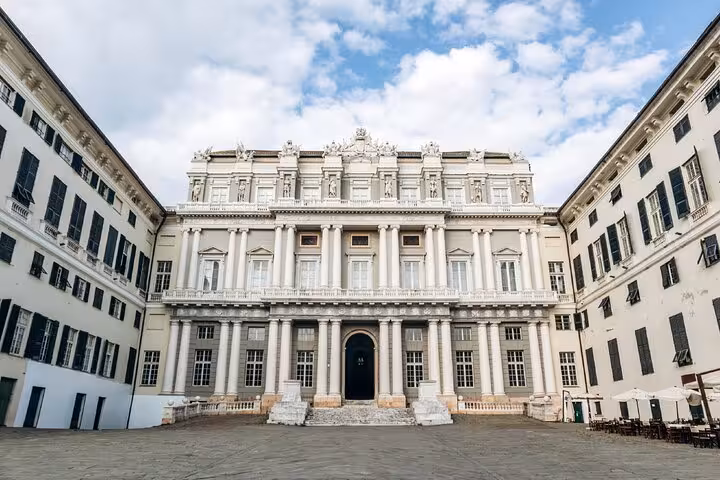 Palazzo Ducale courtyard facade in Genoa, Italy, featuring classical columns and ornate white architecture