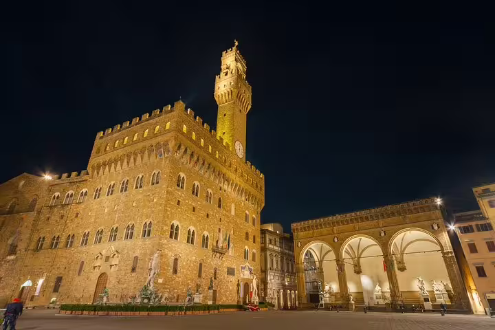 Palazzo Vecchio and Loggia dei Lanzi illuminated at night in Florence's Piazza della Signoria