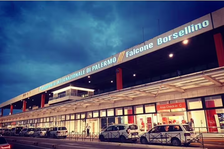 Falcone Borsellino Palermo Airport exterior at dusk, starting point for private transfer to Hotel Porta Felice in city center
