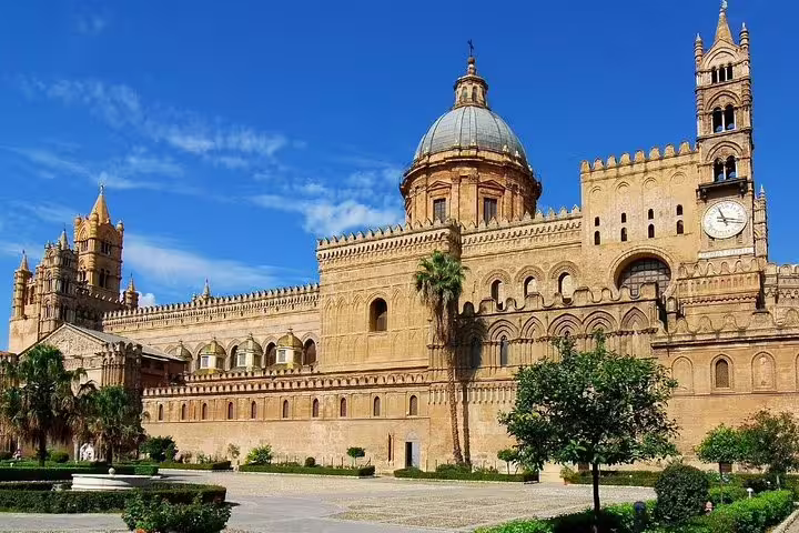 Historic Palermo Cathedral and gardens under blue sky, ideal landmark near Grand Hotel Piazza Borsa private airport transfer