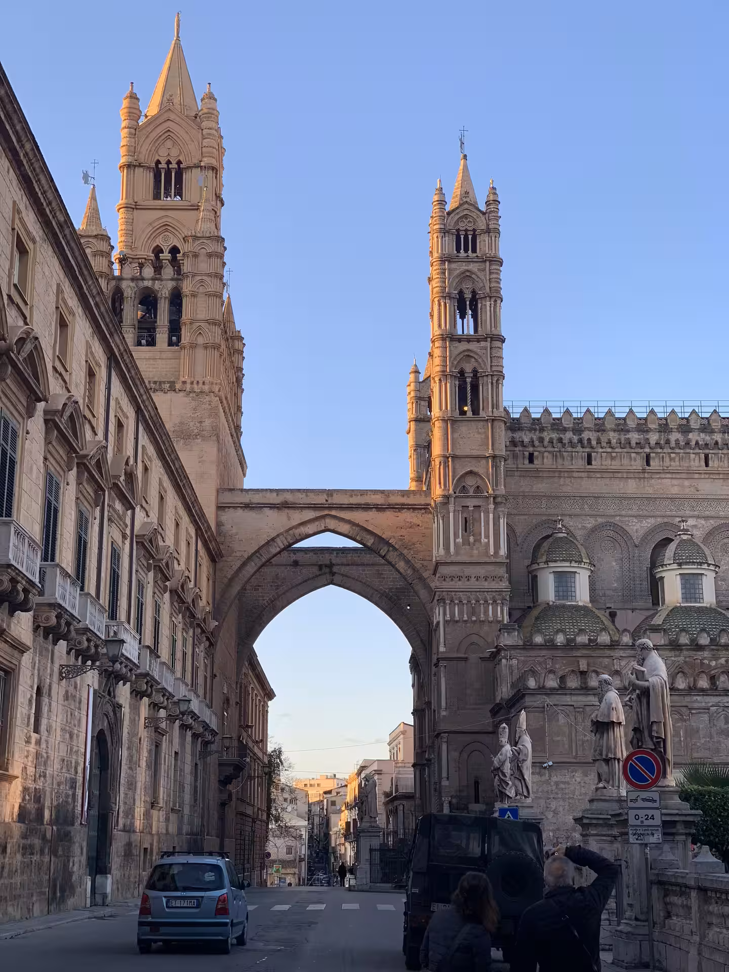 Street view of Palermo Cathedral towers and archway at dusk, seen on private Monreale, Palazzina Cinese and Mondello tour