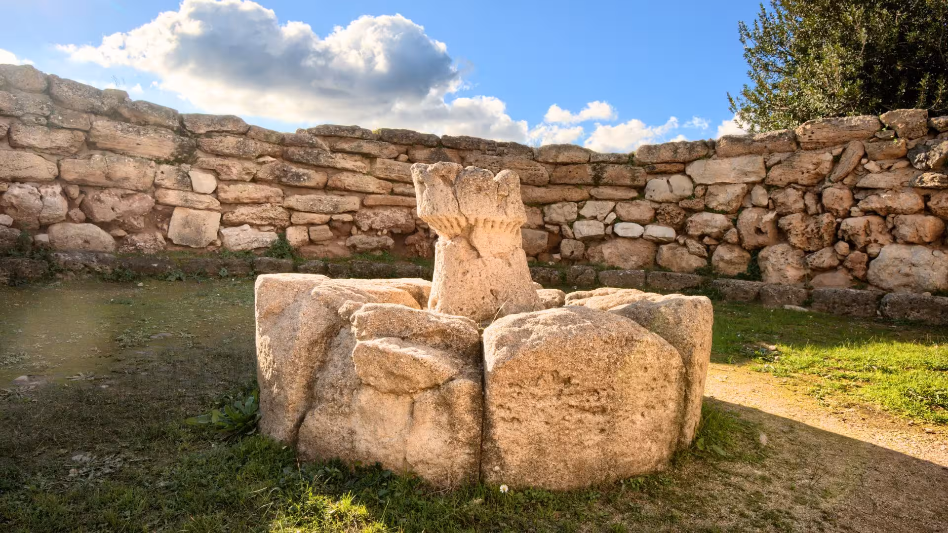 Visit the central courtyard of Palmavera Nuraghe in Alghero, featuring a unique stone structure.