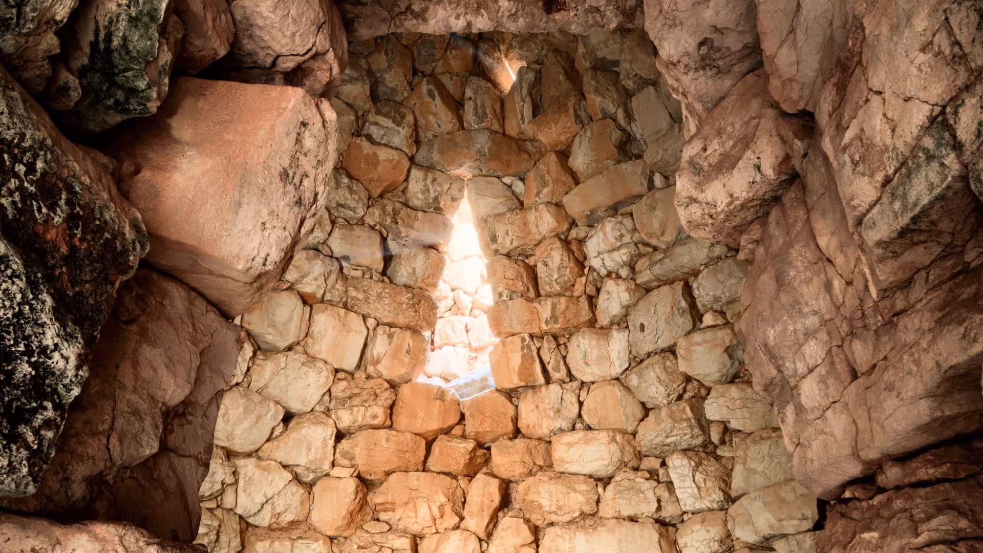 Discover the intricate stonework of Palmavera Nuraghe's interior, showcasing ancient architecture.