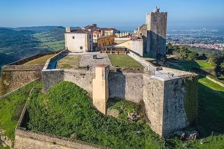 Aerial view of the historic Palmela Castle, offering panoramic vistas of rolling hills and the Setúbal region.