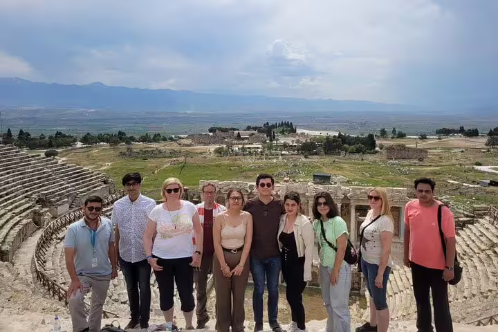Tour group exploring the ancient amphitheater during a private Pamukkale tour from Kusadasi Port.